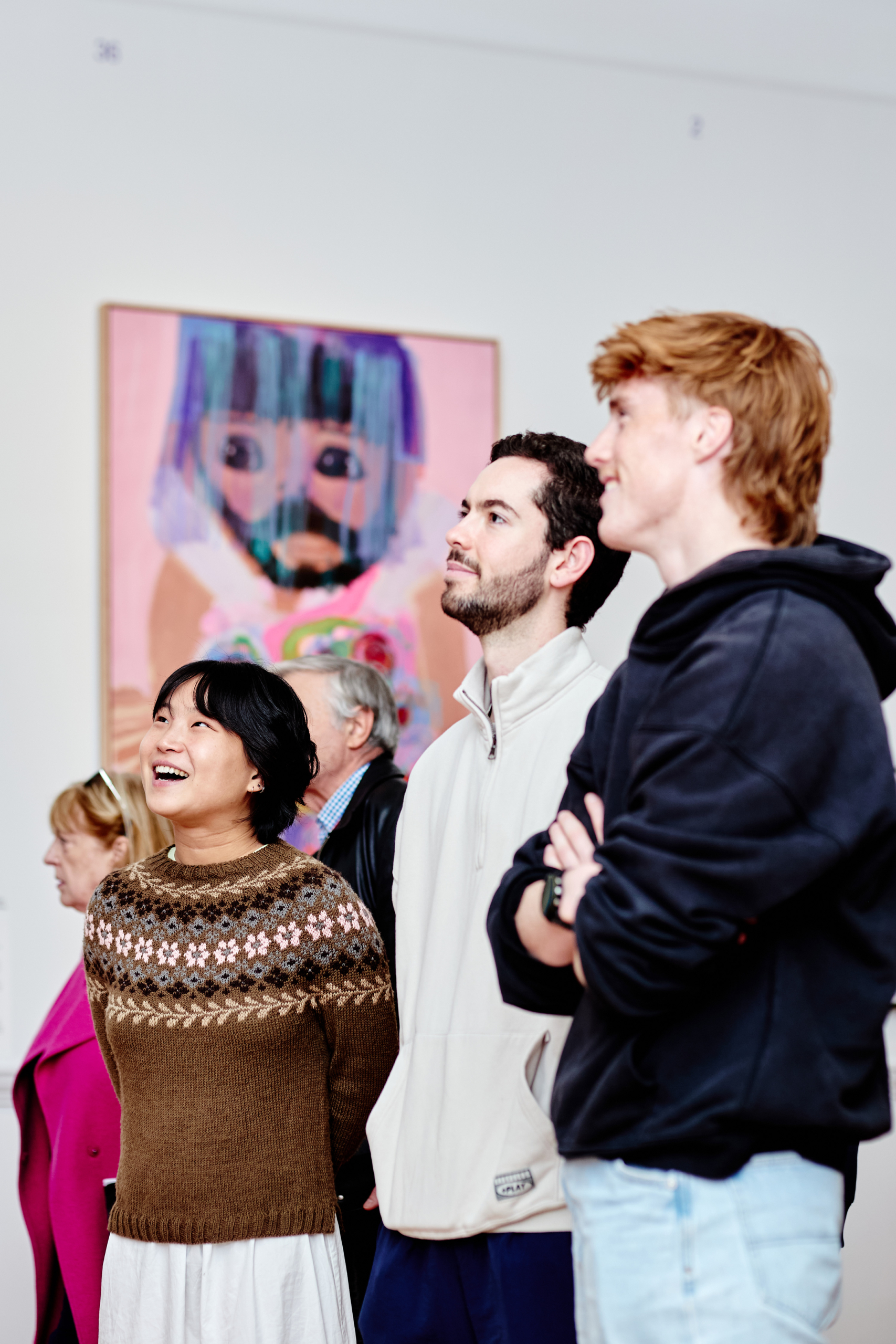 Visitors looking at artworks